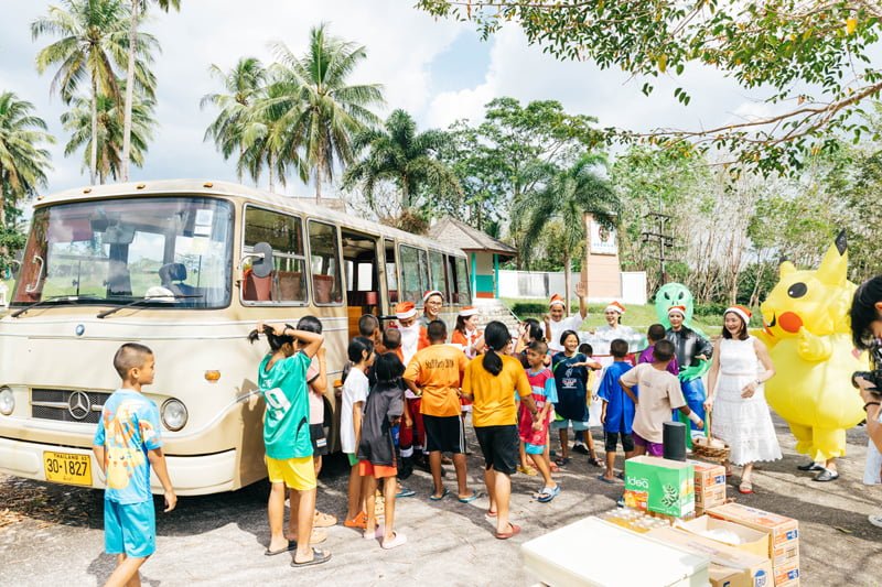 The Happy Bus delivers a special present on boxing day as the children gather around the bus.